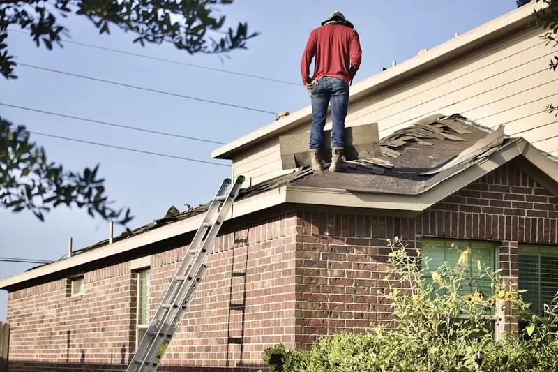 Professional roofer working on a residential roof in Brier